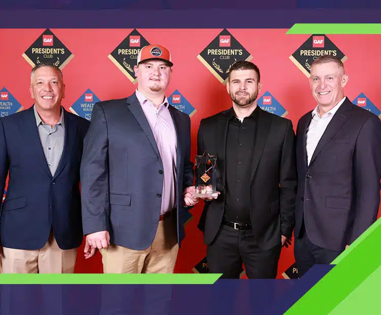 Owner Tyler Johnson of Johnson Roofing Solutions recieving the GAF Presidents Award in Northwest Florida